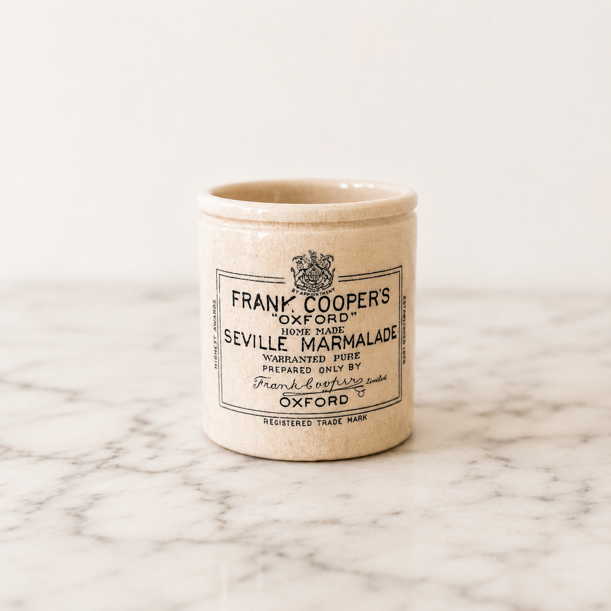 Frank Coopers Oxford Seville Marmalade Ceramic jar with a label on a marble surface
