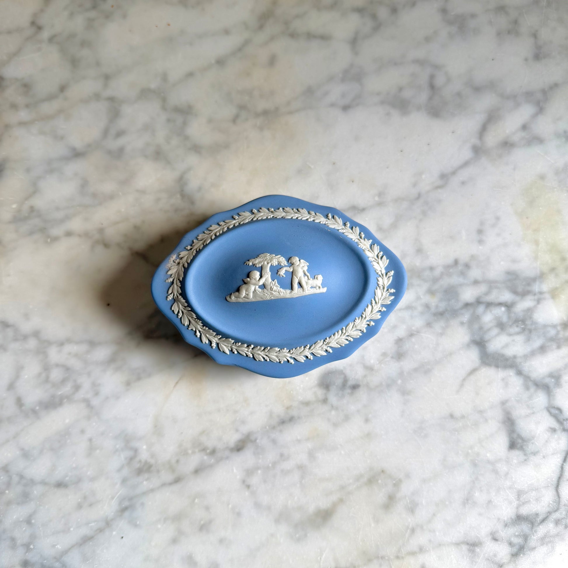 Blue decorative dish with intricate design on a marble surface