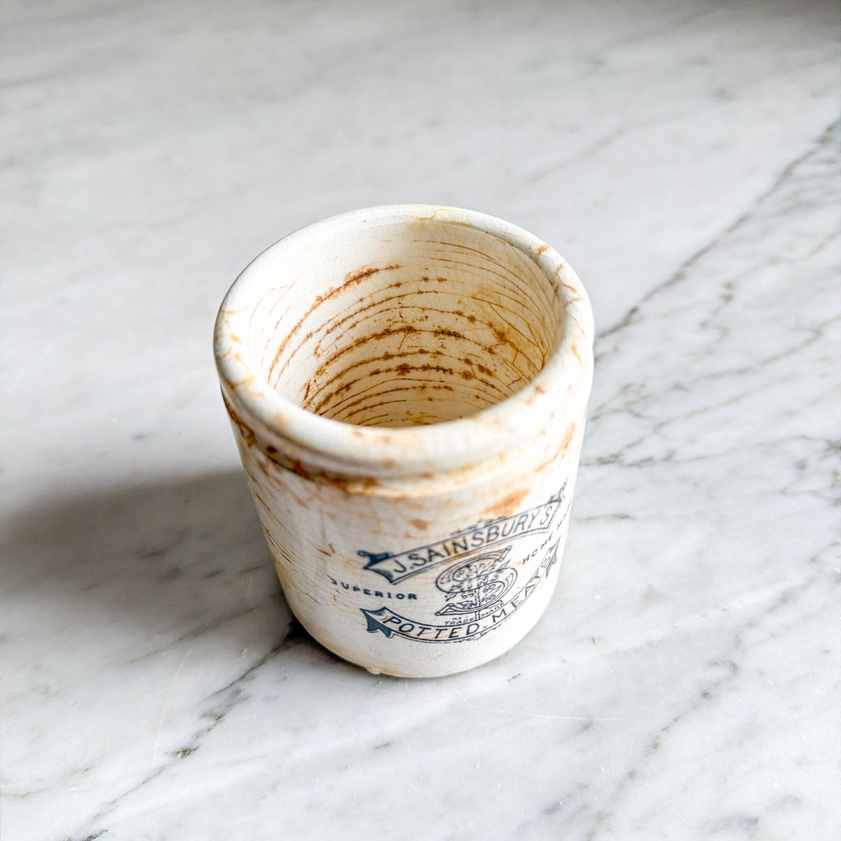 Interior of vintage J. Sainsbury's potted meats ceramic pot with crazing