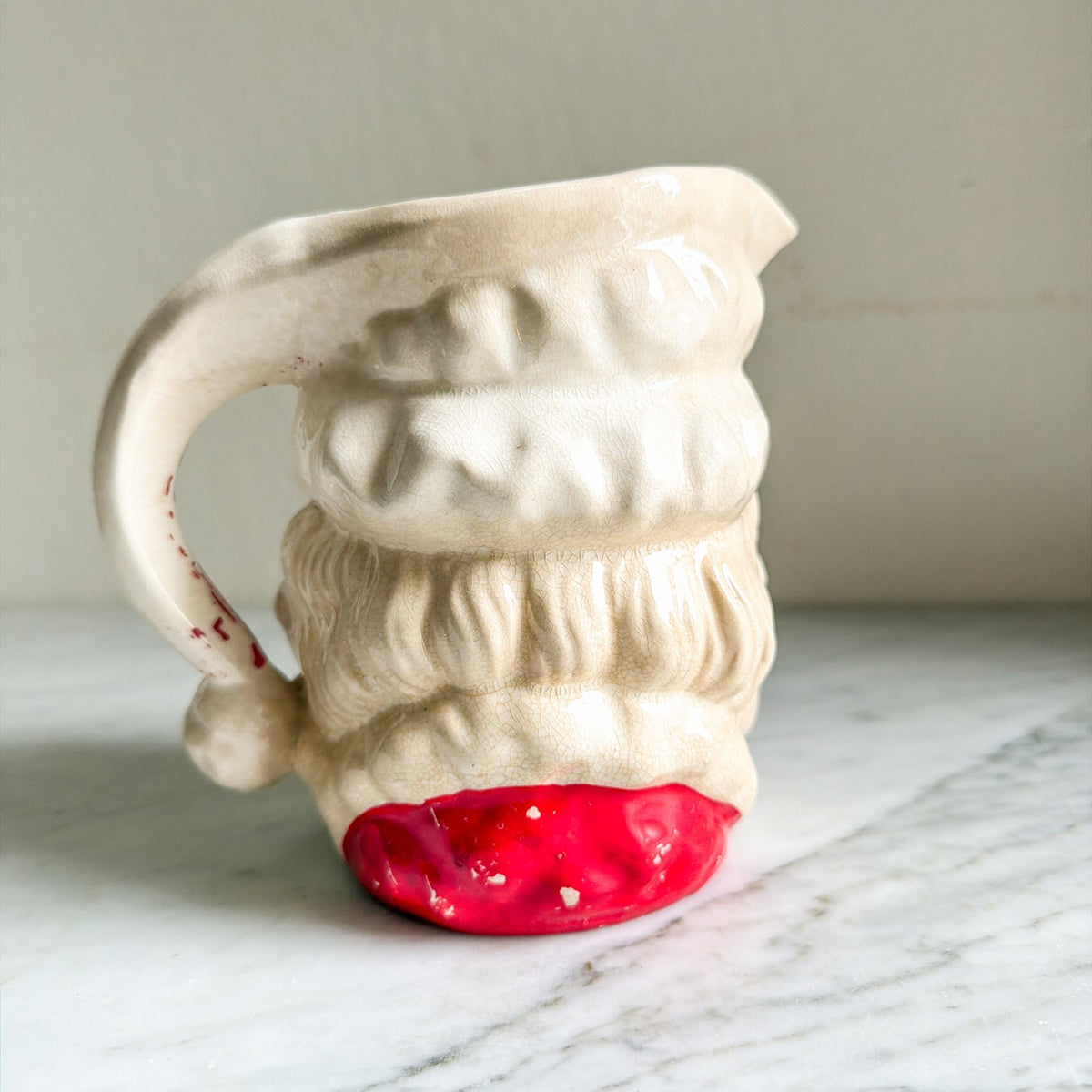 Vintage ceramic Santa pitcher back view with red base
