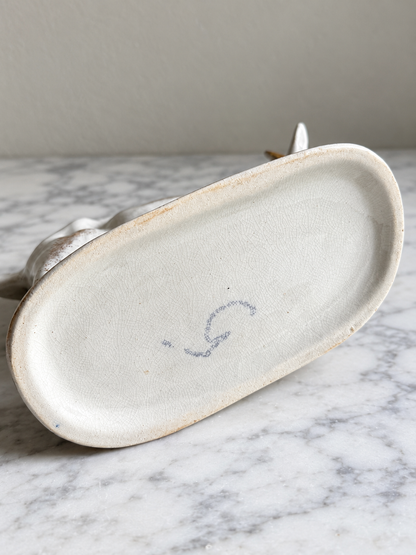 Underside of vintage ceramic cow creamer showing base and maker's mark, edited image