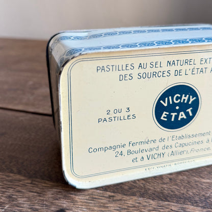Vichy Etat tin on a wooden surface with a blurred background