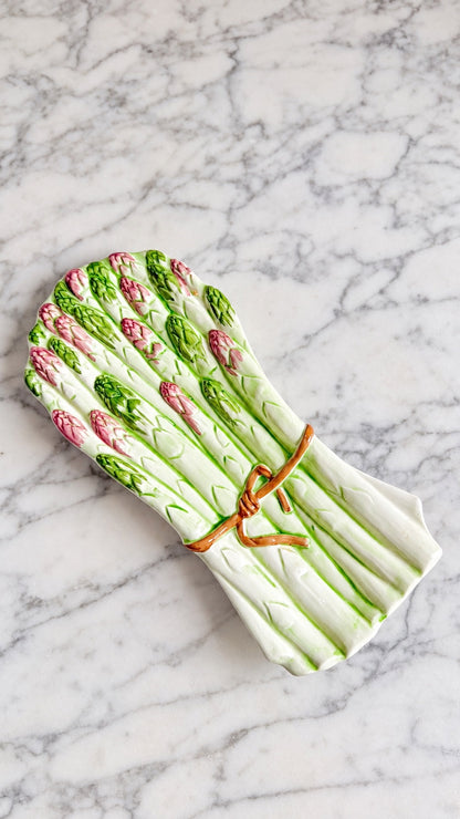 Vintage Italian majolica asparagus serving dish with green stalks, pink tips, and tied ribbon detail